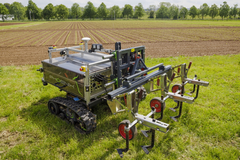 The photo shows a crossed-out tractor spreading pesticides in the field.