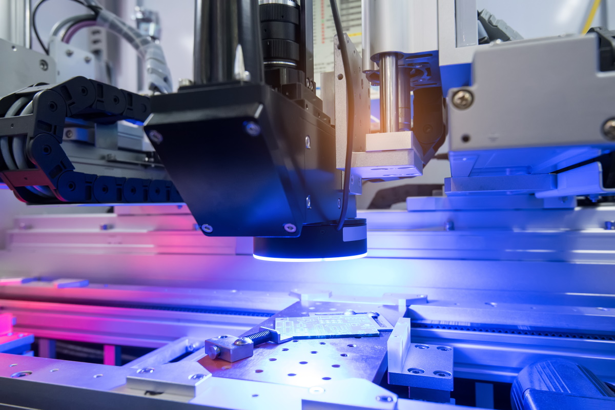 A machine checks the surface of a metal piece.